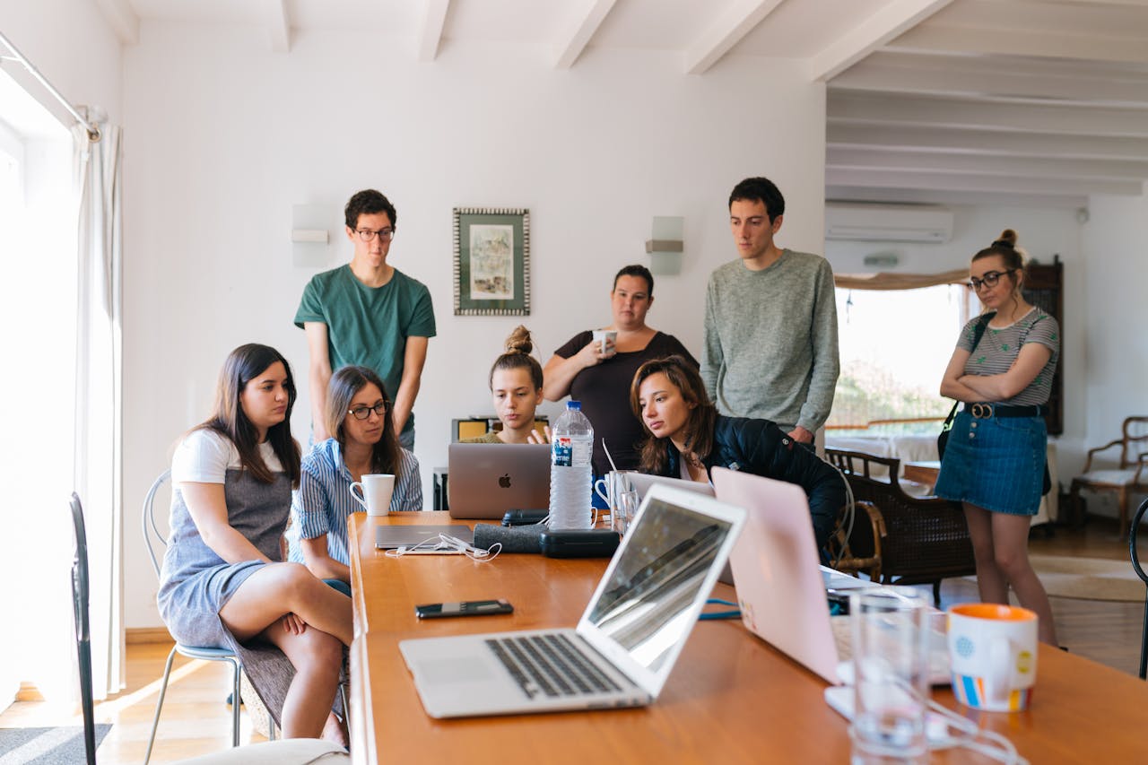 Home Group of young professionals engaged in a collaborative meeting in a modern office setting.